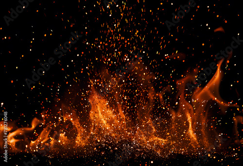 Flame of fire with sparks on a black background photo