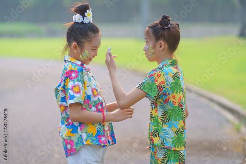 Songkran Water Festival Thailand. Asian young travel group wearing colorful Thai dress according to Thai culture and tradition for the Songkran Festival in Thailand.