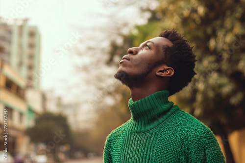 AI Generated Young man in contemplation wearing a green sweater. Generative AI image photo