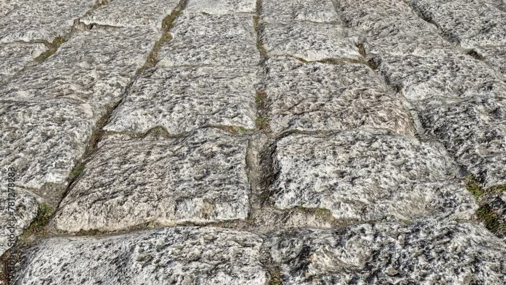 Old cobblestone pavement with a rough surface close-up. Old cobblestone pavement with a rough surface close-up.