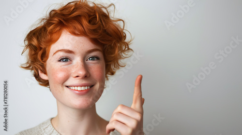 Close-up of a cheerful young redhead with freckles