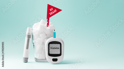 Glass full of sugar cubes with no sugar red sign and blood glucose meter and lancet on green background, diabetes concept
