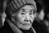 An elderly woman exudes timeless grace and elegance in a black and white portrait.