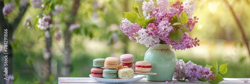 Picnic, beautiful bouquet of lilacs in vase, multicolor macaroon, sweet cakes, macaron in sunny garden. Concept of leisure, family weekend, spring mood. Banner image for design, wallpaper. Copy space photo