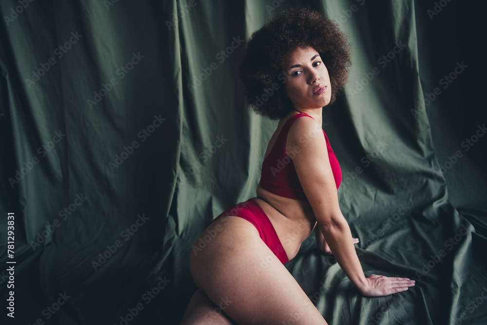 Naklejka premium Photo portrait of lovely young lady sexy posing dressed red lingerie green studio background no filter self acceptance all body perfect