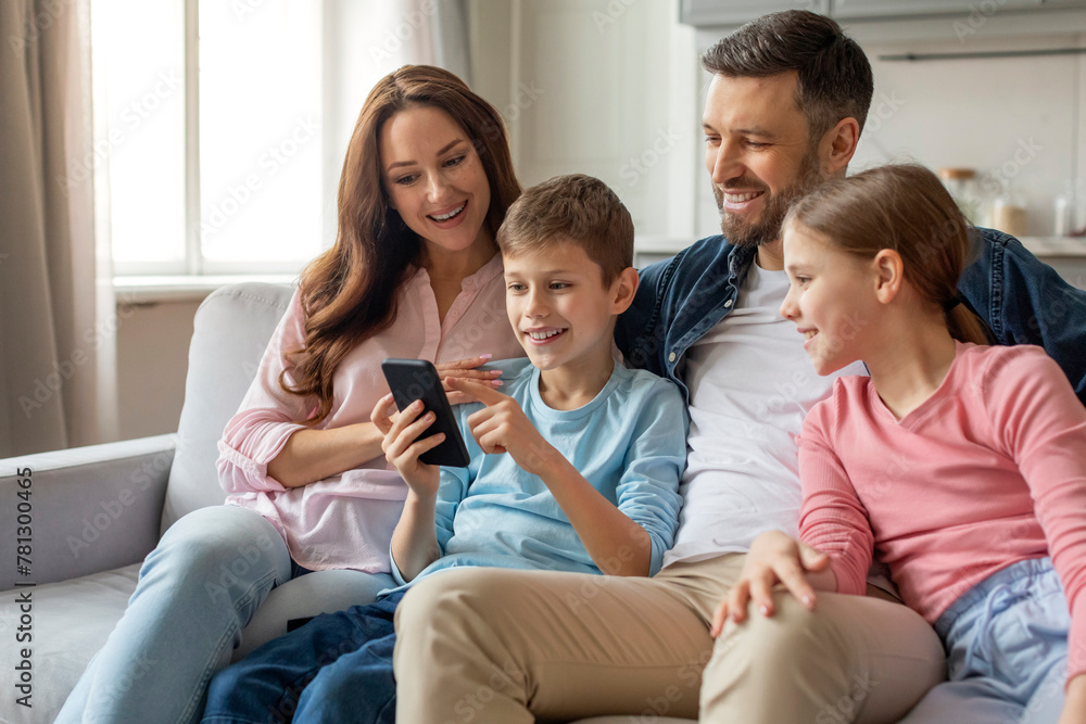 Family interacting with smartphone together at home Family interacting with smartphone together at home