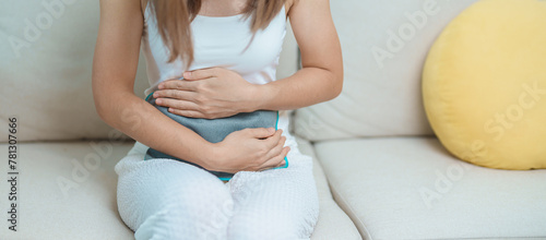 Menstruation period cycle of monthly and Stomachache concepts. woman having abdomen pain and menstrual ache with hot water bottle, illness female suffer from premenstrual ache and body Health problem