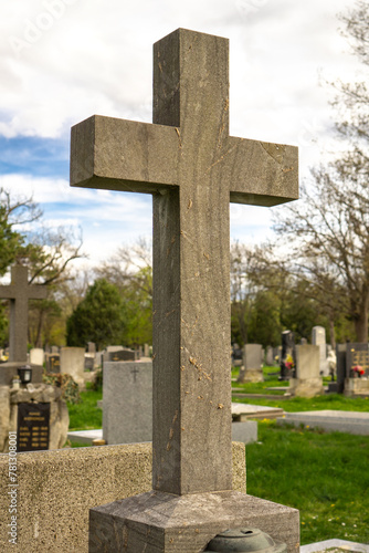 Stone cross on a grave in a cemetery in Vienna