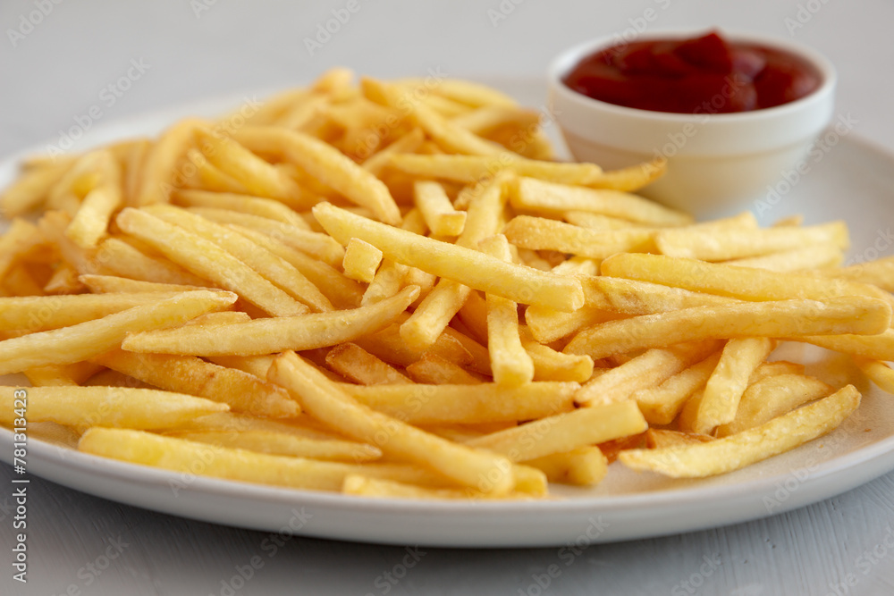 Fried French Fries with Ketchup on a Plate, low angle view. Close-up.