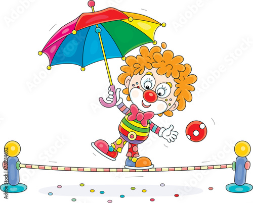 Funny red curly-headed circus clown equilibrist playing with a multi colored striped umbrella and balancing on a taut rope in a fun performance, vector cartoon illustration on a white background