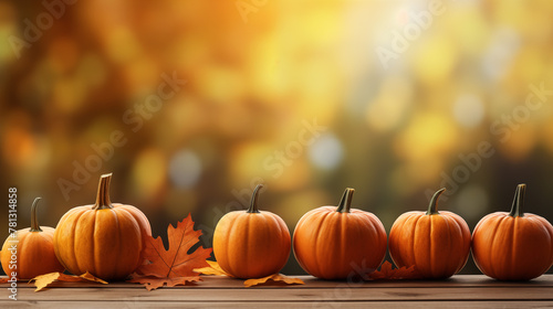 Pumpkins on Wooden Surface Against Golden Autumn Backdrop