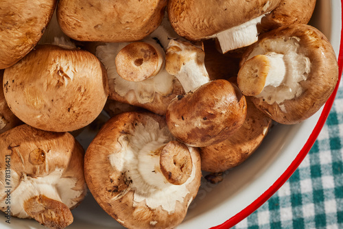 A bowl of raw baby bella mushrooms, Agaricus bisporus, also called crimini, Italian, portabello, or portabella.