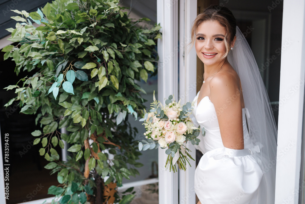 Gorgeous bride in beautiful wedding dress hold flowers in hands and waiting for groom Gorgeous bride in beautiful wedding dress hold flowers in hands and waiting for groom