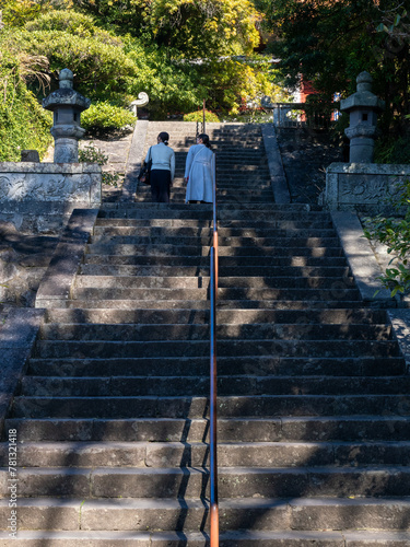 Two female tourists climbing the stairs leading to Sofukuji temple in Nagasaki, Japan