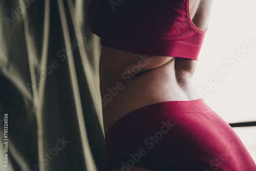 Unretouched cropped photo of girl stand back wear red lingerie in studio interior background