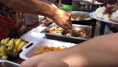 Church members enjoy gathering together to share a potluck of traditional foods. The dishes are served on a long table, where everyone can help themselves to their favorites. photo