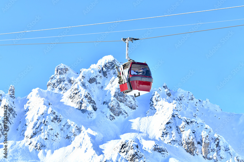 Obraz premium Ski lift over the slopes of Courchevel ski resort, French alps