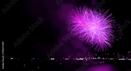 Spectacular purple colored fireworks exploding in to the night sky over the bay