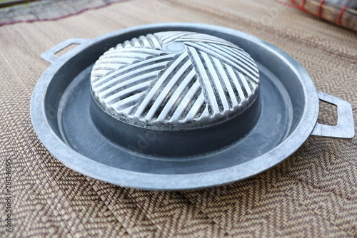 Empty Iron hot pan for making Barbecue in Thai style which has both grilling and broth sections. Pan for Korean Barbecue in Thai Style are two handles on each side. Use with a charcoal stove.
