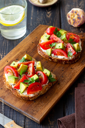 Toast with white cheese, tomatoes and avocado. Healthy eating. Vegetarian food.