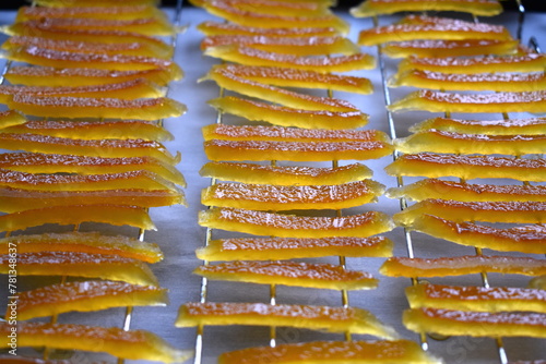 Candied orange peels drying on a wire rack. Before sprinkling with granulated sugar.