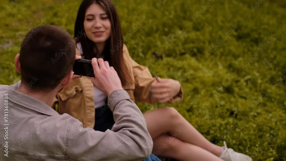 Young love: a teenage couple taking photos of each other on a phone. Capturing a touching moment on vacation, photo editing apps, travel routes, and tourist services. Young love: a teenage couple taking photos of each other on a phone. Capturing a touching moment on vacation, photo editing apps, travel routes, and tourist services.