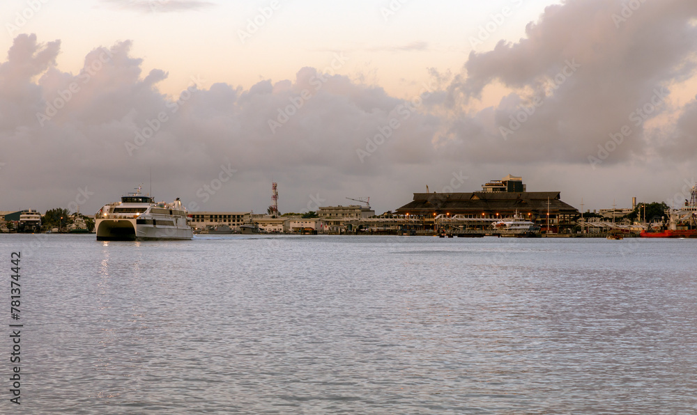 A passenger ferry sails at dusk from the main ferry terminal of Papeete, the capital of French Polynesia, on the island of Tahiti.