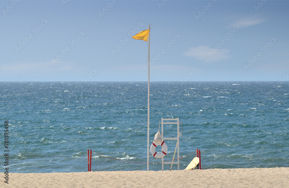 Lifeguard watch station on a beach with a yellow flag, summer, vacations