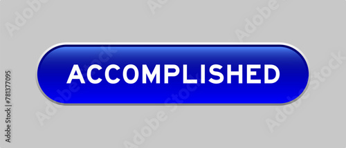 Blue color capsule shape button with word accomplished on gray background
