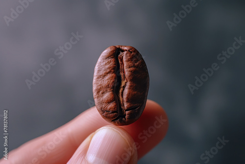 Hand holding coffee bean isolated with copy space, healthy food