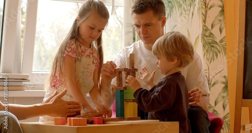Social Skills: Playing with building blocks in a family setting provides children with opportunities to practice social skills such as sharing, taking turns, and cooperating with others. Dad with kids
