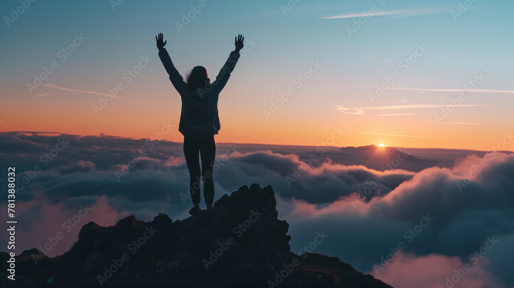 a person raising hands on the top of the mountain, achievement or success concept a person raising hands on the top of the mountain, achievement or success concept