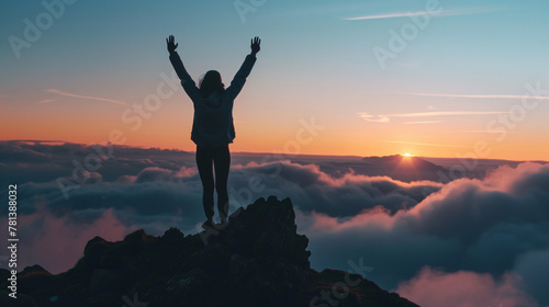 a person raising hands on the top of the mountain, achievement or success concept 