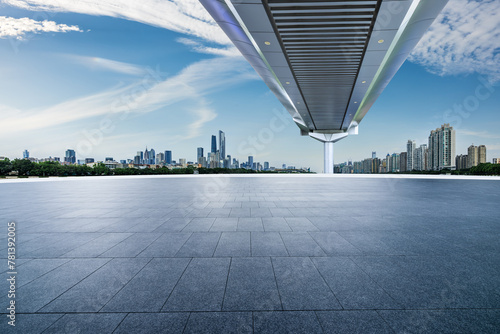 Empty square floor and pedestrian bridge with modern city buildings in Guangzhou photo