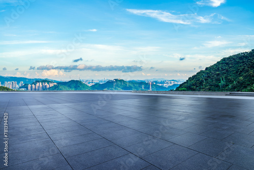 Empty square floor and green mountains with city skyline in the morning © ABCDstock