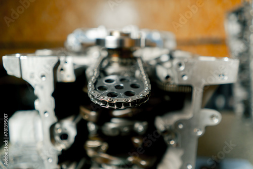 close up of a set of crankshaft pistons on car mechanic's table chain