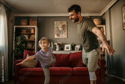 Father and daughter share quality time while working out in their chic living space