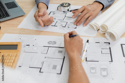 Architects at a meeting discussing house plans are reviewing draft house plans. Projects assigned by customers and customized design before delivery Interior design and decoration ideas photo