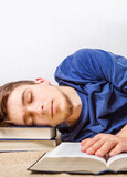 Young Man sleeping with a books