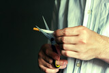 Person cutting a Cigarette with Scissors