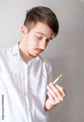 Young Man looking at a Cigarette