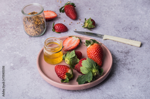 Fresh strawberries with honey and granola photo