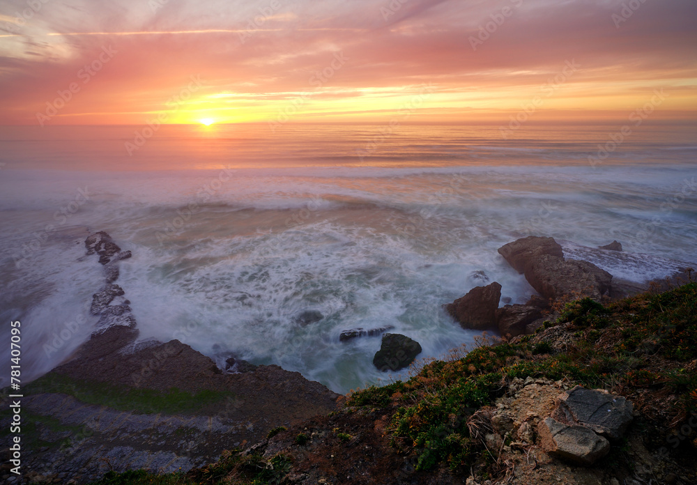 Sunset over the ocean on the coast of Sintra, Portugal