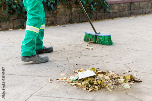 Картината върху платно a municipal worker sweeping the dust in the park