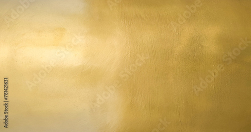 Gold wall texture background. Yellow shiny gold foil paper sheet surface, vibrant golden luxury wallpaper © merrymuuu