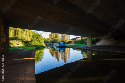 Grand Union Canal under the bridge of dural carriageway on sunny day in Milton Keynes photo