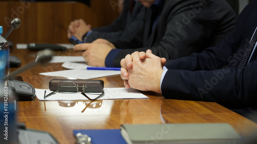Business team of three men during a business meeting or negotiation. Photo. No face. Selective focus.