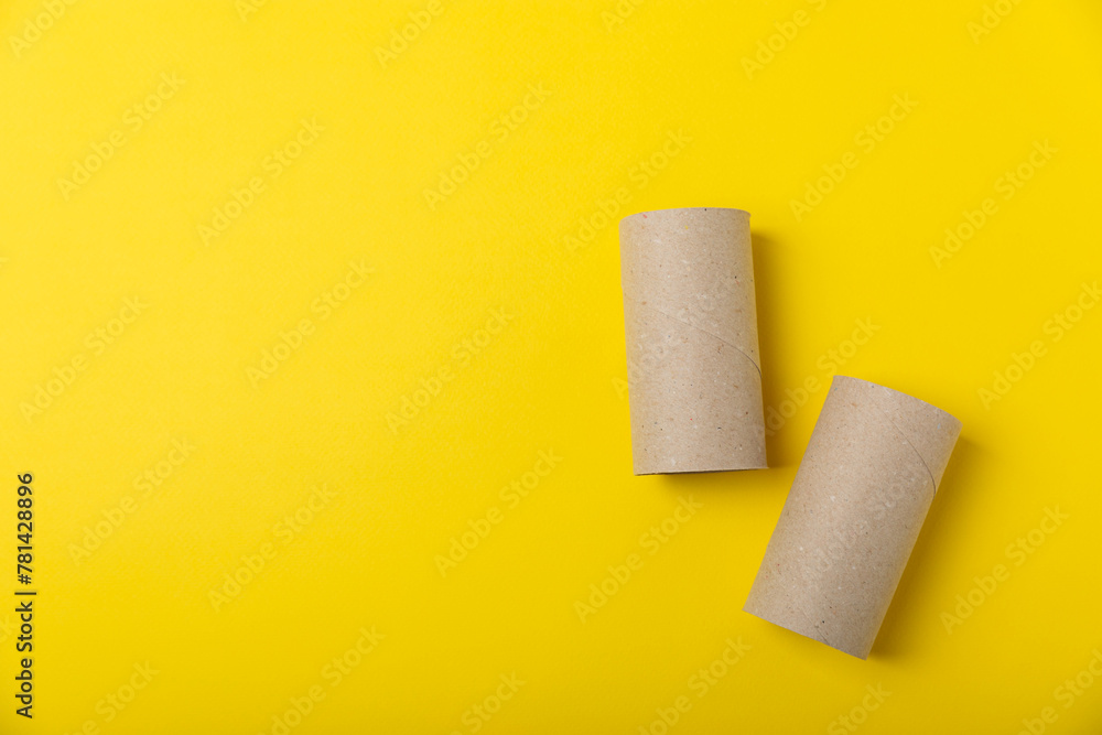 Empty toilet paper roll. Empty toilet paper rolls for the toilet, on a bright yellow background. Paper tube of toilet paper. Place for text. Copy space. Flat lay. Eco-friendly reuse recycle Empty toilet paper roll. Empty toilet paper rolls for the toilet, on a bright yellow background. Paper tube of toilet paper. Place for text. Copy space. Flat lay. Eco-friendly reuse recycle