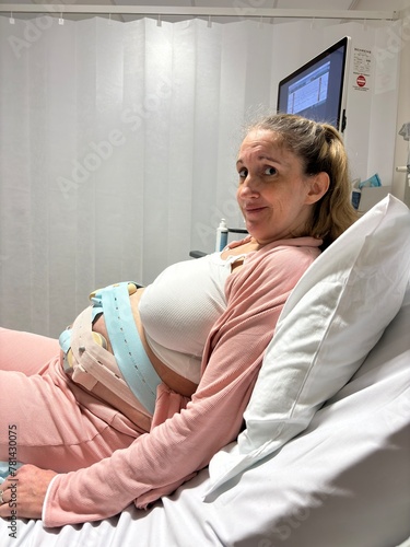 A woman in labour on her hospital bed at the delivery suite.