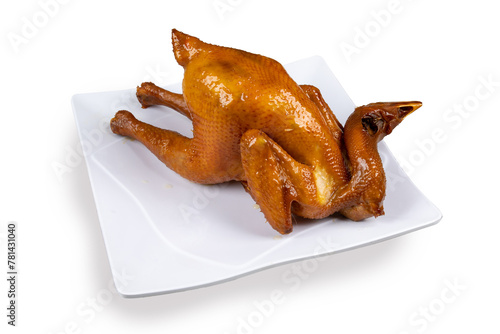 An Asian or Chinese BBQ whole chciken with the head attached isolated on white